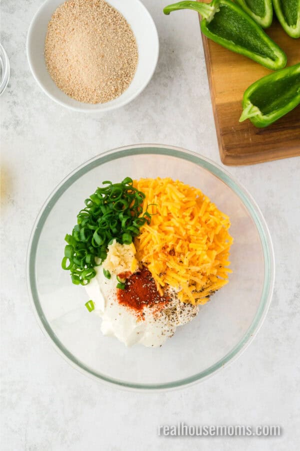 cream cheese, shredded cheddar, green onion, garlic, paprika, salt, and pepper in a mixing bowl for jalapeno popper filling