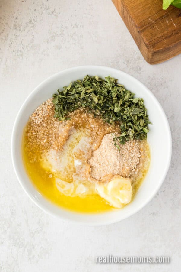 breadcrumbs, melted butter, and dried parsley in a bowl