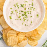 bowl of 1 minute french onion dip surrounded by potato chips with recipe name at the bottom
