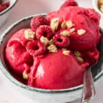 square image of 2-ingredient banana berry ice cream topped with granola and raspberries