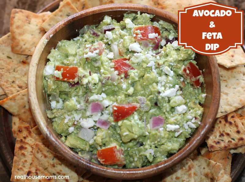 avocado and feta dip with crackers on a platter