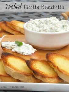 herbed ricotta bruschetta in a bowl with toasted bread slices