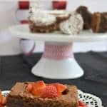 symphony brownies with sliced strawberries on a doily