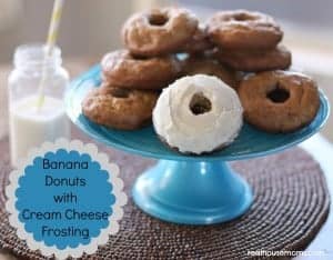 banana donuts with cream cheese frosting on a blue cakestand