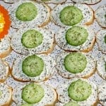 open faced cucumber sandwiches on a platter