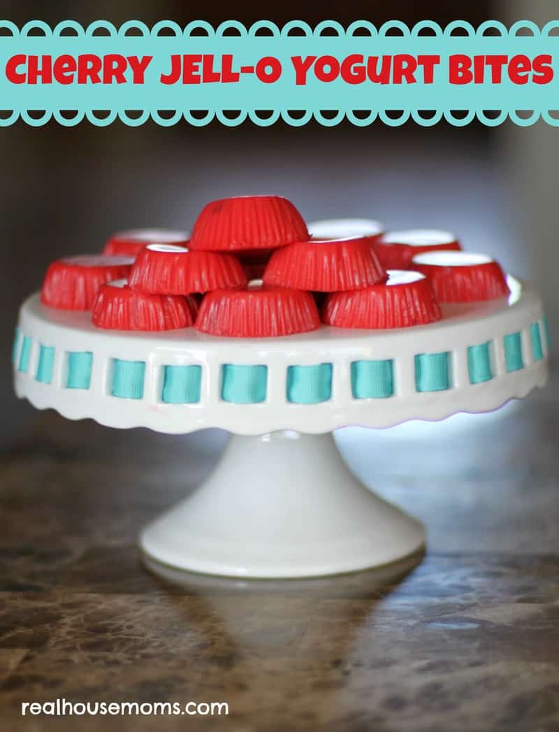 Cherry jell-o yogurt bites on a elevated cake plate with blue trim