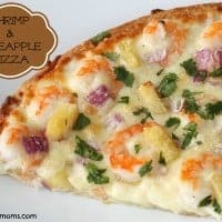 shrimp and pineapple pizza topped with red onion and cilantro