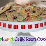 starburst jelly bean cookies on a white cake plate with red trim