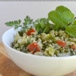 Tabouli in a white bowl with herb garnish