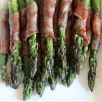 prosciutto wrapped asparagus on a plate