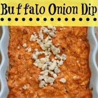 buffalo onion dip topped with crumbled cheese in a white serving bowl