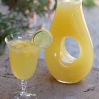 key lime whipped lemonade in a glass and pitcher