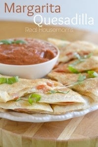 Margarita quesadillas on a plate with dip
