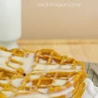 pumpkin spice waffles stacked with a cream cheese glaze