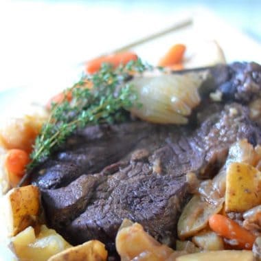 classic pot roast on a platter with root vegetables