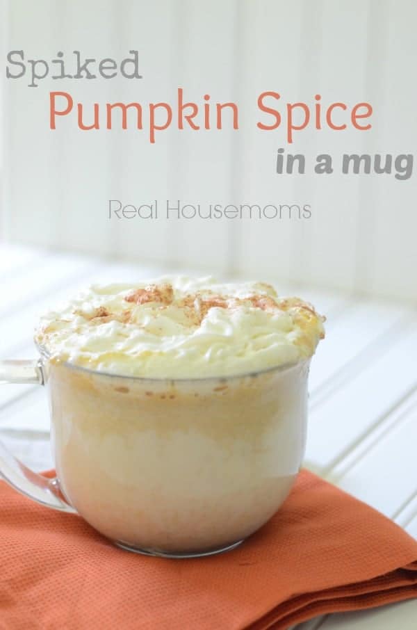 spiked pumpkin spice in a mug topped with whipped cream