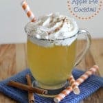 warm apple pie cocktail in a mug topped with whipped cream