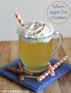 warm apple pie cocktail in a mug topped with whipped cream