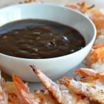 baked coconut shrimp on a platter with garlic plum dipping sauce