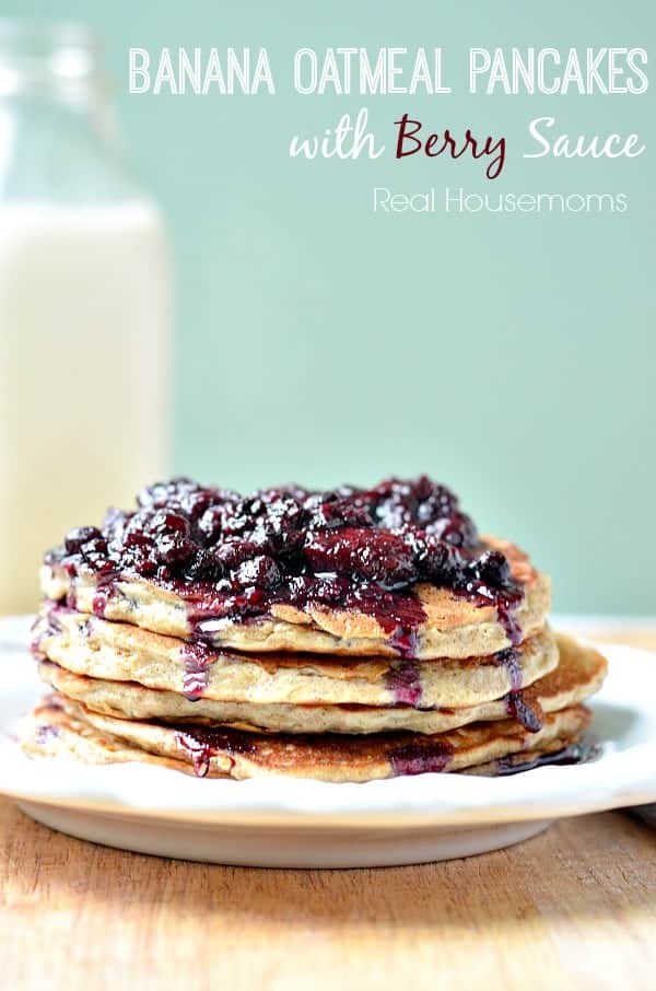 stack of banana oatmeal pancakes topped with berry sauce