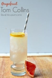 grapefruit tom collins in a glass with lemon slice and grapefruit wedge