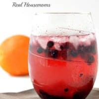 portland breeze rum cocktail in a glass with ice and berries