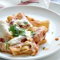 cheesy baked rigatoni on a white plate