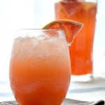 grapefruit ginger sparkler in a glass with a slice of grapefruit