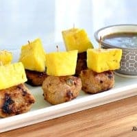 pineapple teriyaki turkey meatballs topped with pineapple on a serving platter