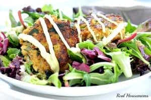 spring mix salad topped with quinoa crab cakes