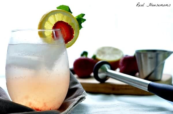 Moscato Strawberry Lemon Mojito in a glass next to a cocktail muddler