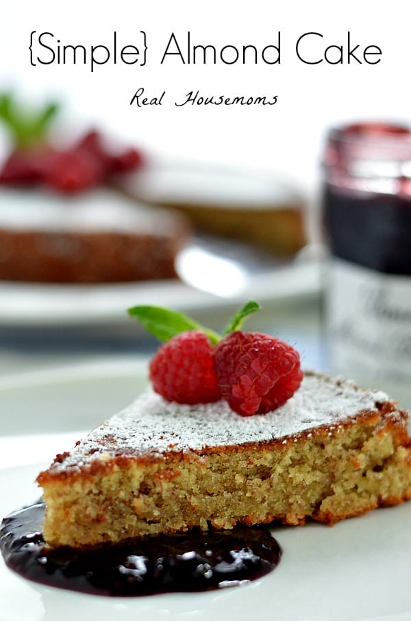 simple almond cake slice served with sauce and raspberries