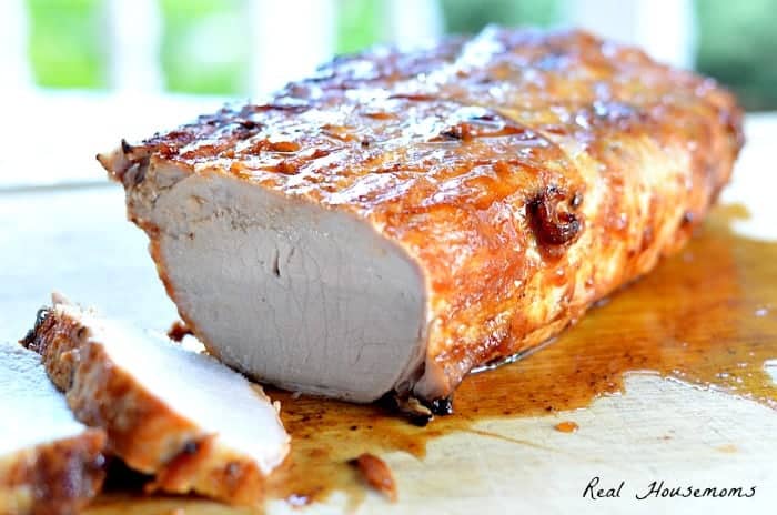 Grilled BBQ Pork Roast displayed on wooden cutting board