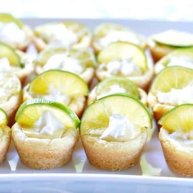 Key Lime Pie Cookie Cups shaped like mini cupcakes topped with Lime wedges