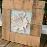 Pallet book page art Frame made from wood with book pages folded like a flower in the middle of frame