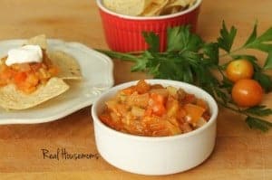 Homemade Garden Salsa with i side of chips displayed in a small white sharing bowl