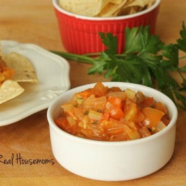 Homemade Garden Salsa with i side of chips displayed in a small white sharing bowl