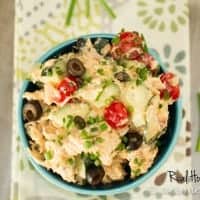 Hummus Chicken Salad displayed in a blue bowl topped with black olives
