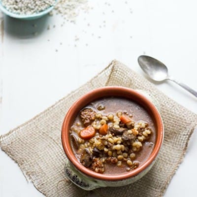 close up of Barley Soup served in a orange bowl