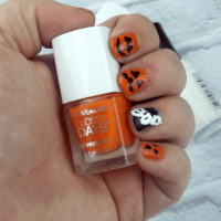 Halloween Nail Art Tutorial photo of halloween nails holding Orange nail polish