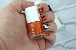 Halloween Nail Art Tutorial photo of halloween nails holding Orange nail polish