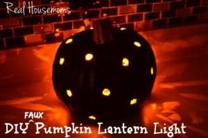 Pumpkin Lantern Light black pumpkin with drill holes to let light escape