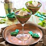 Andes Mint Martini served in a martini glass with green sugar on the rim. with a side of chocolate mint