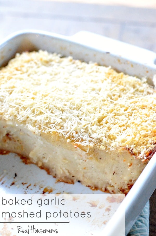 Baked Garlic Mashed Potatoes served in a white baking dish with half of the dish filled