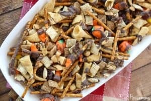 Fall Chex Mix, chex mix with added candy corn seved in a white baking dish