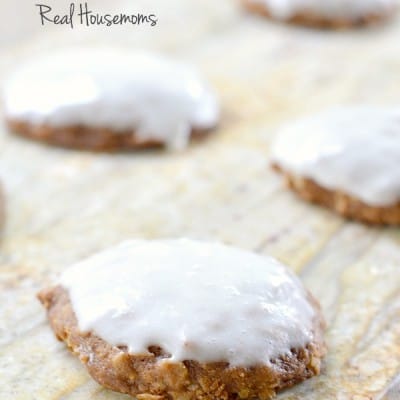 Pumpkin Oatmeal Cookies with Cream Cheese Icing served on a wood cutiing board