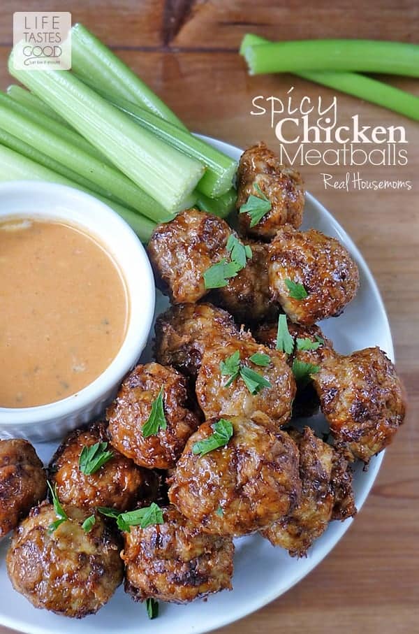 Spicy Chicken Meatballs on a platter with dipping sauce & celery