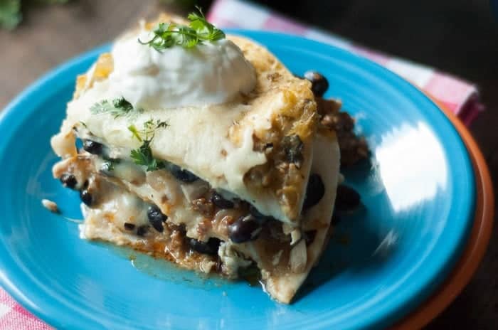 Black Bean Chorizo Enchilada Casserole topped with sour cream