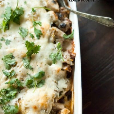 Easy black bean and chorizo enchilada casserole recipe. Served in a white baking dish