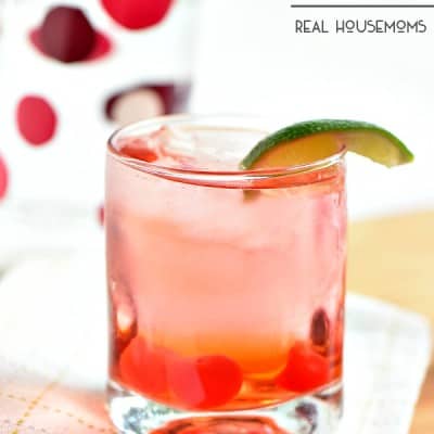 Dirty Shirley cocktail. Adult Shirley Temple. added liquor served in a short glass garnished with a lime
